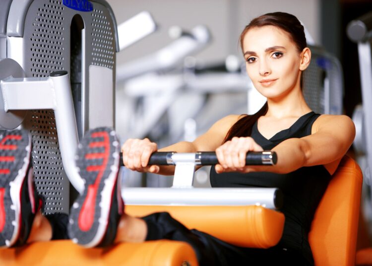 Beautiful woman exercising at the fitness gym
