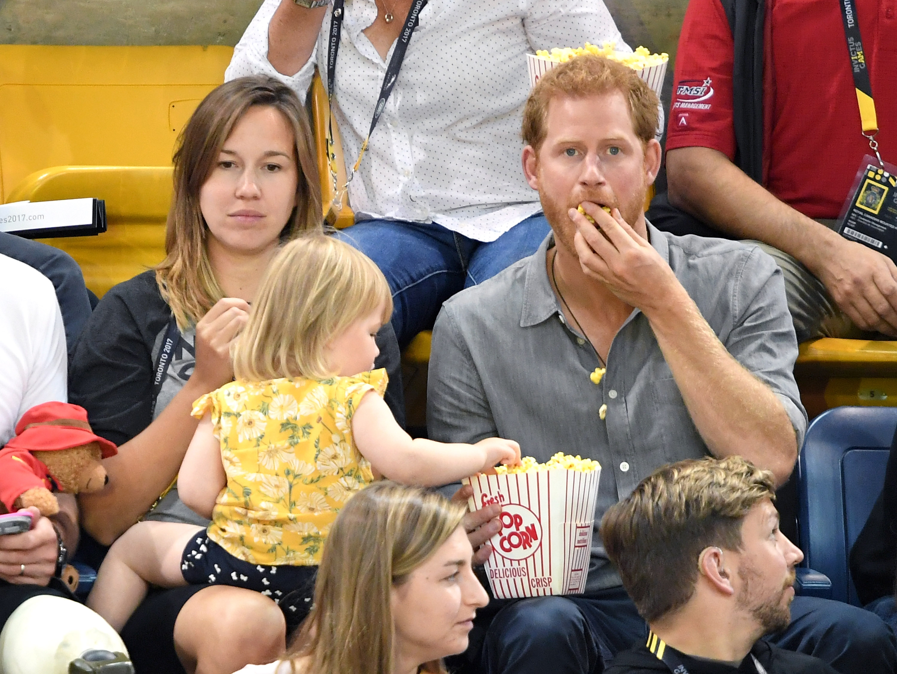 TORONTO, ON - SEPTEMBER 27: Prince Harry with Hayley Henson, wife of British Paralympian Dave Henson and their two-year-old daughter Emily attend the Seated Volleyball on day 5 of the Invictus Games Toronto 2017 at Mattamy Athletic Centre on September 27, 2017 in Toronto, Canada. The Games use the power of sport to inspire recovery, support rehabilitation and generate a wider understanding and respect for the Armed Forces. (Photo by Karwai Tang/WireImage)