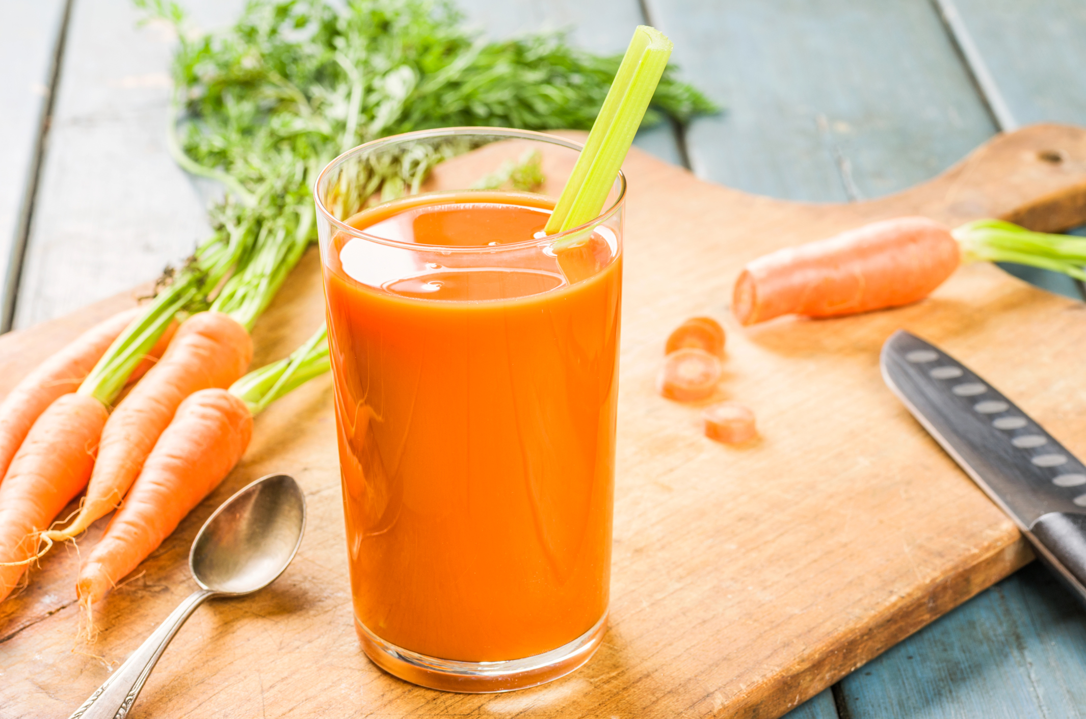Glass of carrot juice with fresh carrots